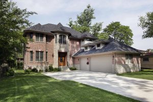 Brick suburban home with new shingle roof installed
