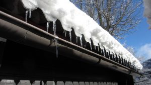 ice dam forming on old metal gutters