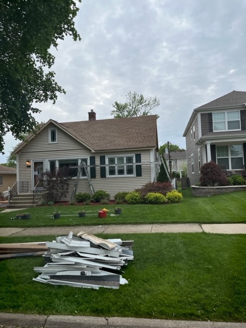 roofers working on a new roof installed in arlington heights