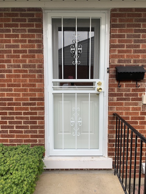 Exterior shot of a new Therma-tru Fiberglass door with a security storm door